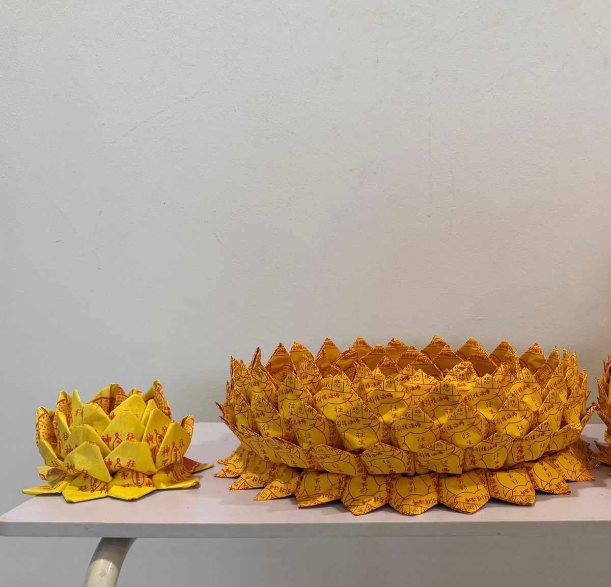 Premium handmade paper lotus compared to a standard folded lotus